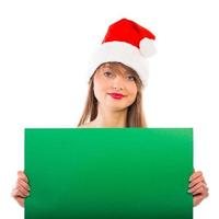 Smiling christmas girl with green placard on white photo