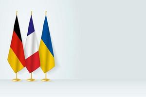 Flags of Germany, France and Ukraine stand in row on indoor flagpole. vector