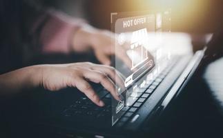 Woman hand typing on keyboard with online shopping concept, Shopping cart part of the network in hand, Innovation in e-Commerce, Online shopping business with selecting shopping cart. photo