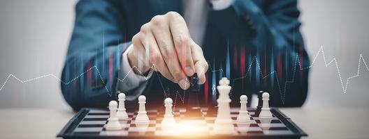 Business strategy competitive ideas concept, Chess game on chess board behind business background. Business present financial and marketing strategy analysis. Investment target in global economy . photo