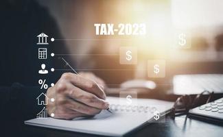 Concept TAX-2023 and refund tax of duty taxation business, graphs, and chart being demonstrated on the screen media, App for selecting tax refund, Keeping track of annual tax expenditures photo