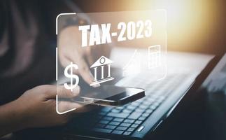 Concept TAX-2023 and refund tax of duty taxation business, graphs, and chart being demonstrated on the screen media, App for selecting tax refund, Keeping track of annual tax expenditures photo