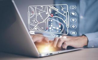 Man using laptop with virtual world and model map with location point , GPS app, icon Travel maps and find places in the online system, all screen graphics are generated,Searching for travel. photo