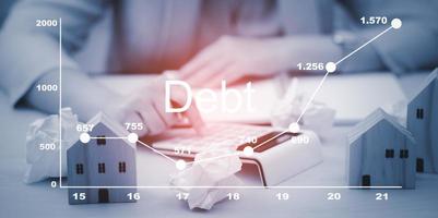 Concept of Debt with optimisation business finance,Man using calculator and taxes icon on technology screen,income tax and property, background for business, individuals and corporations such as VAT photo