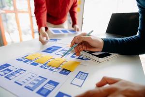 UX graphic designer planning application process development prototype wireframe for web smart phone. Creative digital development agency. photo