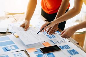 UX developer and ui designer brainstorming about mobile app interface wireframe design with customer breif and color code at modern office. photo