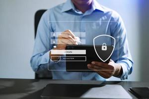 Cyber security concept, Login, User, identification information security and encryption, secure access to user's personal information woman using smart phone and tablet in office photo