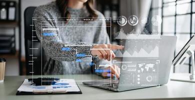 Businesswoman hand Project manager working and update tasks and Gantt chart scheduling virtual diagram.with smart phone, tablet and laptop in office. photo