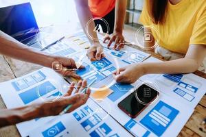 UX developer and ui designer brainstorming about mobile app interface wireframe design with customer breif and color code at modern office. photo