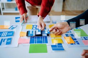 UX graphic designer planning application process development prototype wireframe for web smart phone. Creative digital development agency. photo