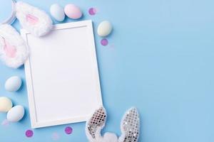 Pastel colored Easter eggs with blank white frame for mockup design photo