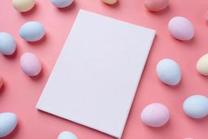 Pastel colored Easter eggs with blank white frame for mockup design photo