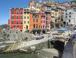 Ligurian town of Manarola with tourists and moored boats photo