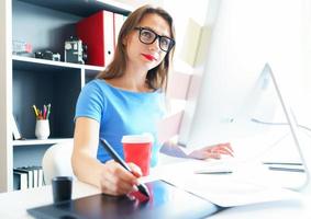Graphic designer drawing something on graphic tablet at the home office photo