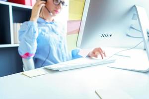 Close-up of woman working in a call center photo