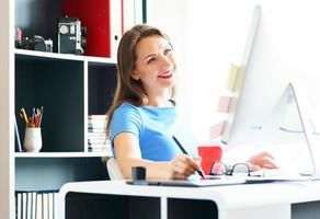 Graphic designer drawing something on graphic tablet at the home office photo