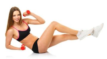 Happy athletic woman with dumbbells doing sport exercise, isolated on white photo