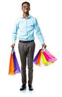 Happy african american man holding shopping bags on white background photo