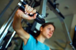 Athletic woman works out on training apparatus in gym photo