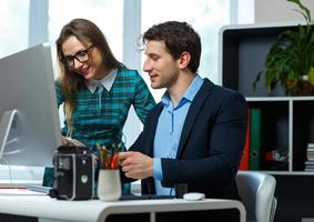 Beautiful young woman and man working from home photo