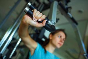 Woman works out on training apparatus in fitness center photo