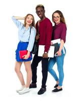 Three happy students standing and smiling with books photo