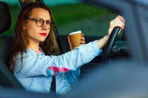 Young businesswoman sending a text message and drinking coffee while photo