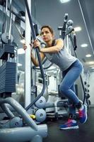 Woman in the gym doing sport exercises photo