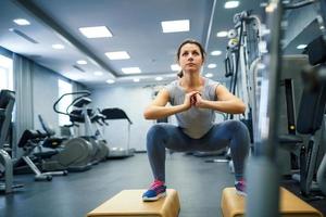 Woman in the gym doing sport exercises photo