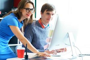 Beautiful young woman and man working from home office photo