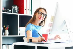 Graphic designer drawing something on graphic tablet at the home office photo