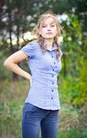 Portrait of young beautiful girl at park photo