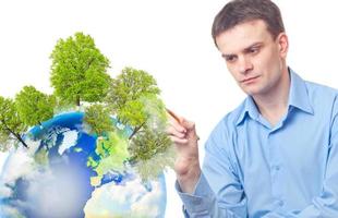 Caucasian businessman drawing tree on the Earth photo