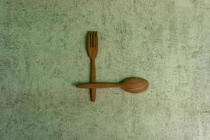 Diet food concept and fat loss. wooden fork and spoon. concept of intermitten fasting. photo