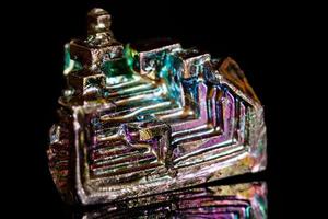 Macro mineral stone Bismuth on black background photo