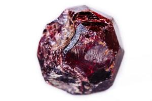 Macro of a mineral garnet stone on a white background photo