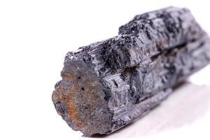 macro mineral stone sherle, schorl, black tourmaline on white background photo