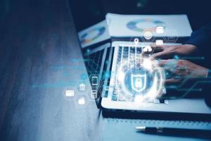 Cybersecurity and privacy concepts to protect data. Lock icon and internet network security technology. Businesswoman protecting personal data on laptop computer with virtual screen interfaces. photo