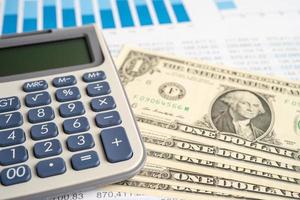 Calculator with US dollar banknotes on chart and graph paper. Finance development, Banking Account, Statistics, Investment Analytic research data economy, Stock exchange trading, Business company photo