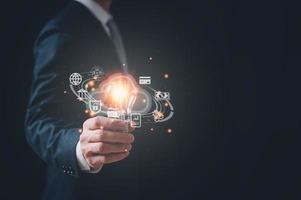 businessman holding Light bulb with cloud computing Global Internet connection.  global internet connection application technology and digital marketing, Digital link tech, big data. photo