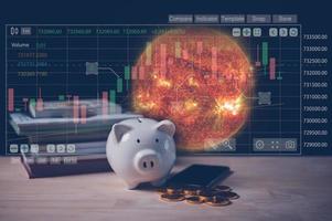 saving and investing strategy in economy crysis comcept, piggy bank and virtual graph, elements of this image furnished by nasa. photo
