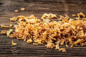 Dried onions on dark rustic wooden background. photo