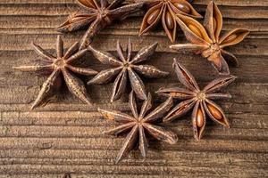 Dried star anise spice on vintage wooden board photo