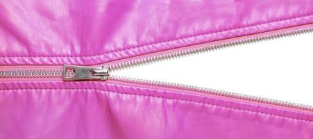 Pink leather texture and open metal zipper isolated on white background photo