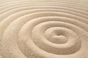 The concept of summer, rest. top view of a sandy background with dunes. The Zen concept. A spiral drawn in the sand photo