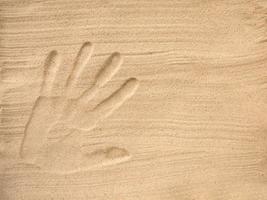 The footprint of a human hand in the sand. Set Sail Champagne Color trend in 2021. Space for text photo