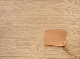 Letter in the sand. Craft paper with twine on the texture of sea sand. photo