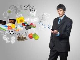 Businessman using mobile phone with touch screen photo