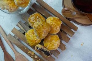 selective focus on crispy dry bakpia snacks usually served with hot tea suitable for eating when breaking the fast in the month of Ramadan. soft focus photo