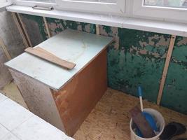 Warming and cladding with slabs of a balcony in an apartment house photo